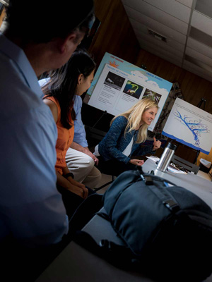 Shara Fisler in a meeting with Khosla and Patrick and other leaders